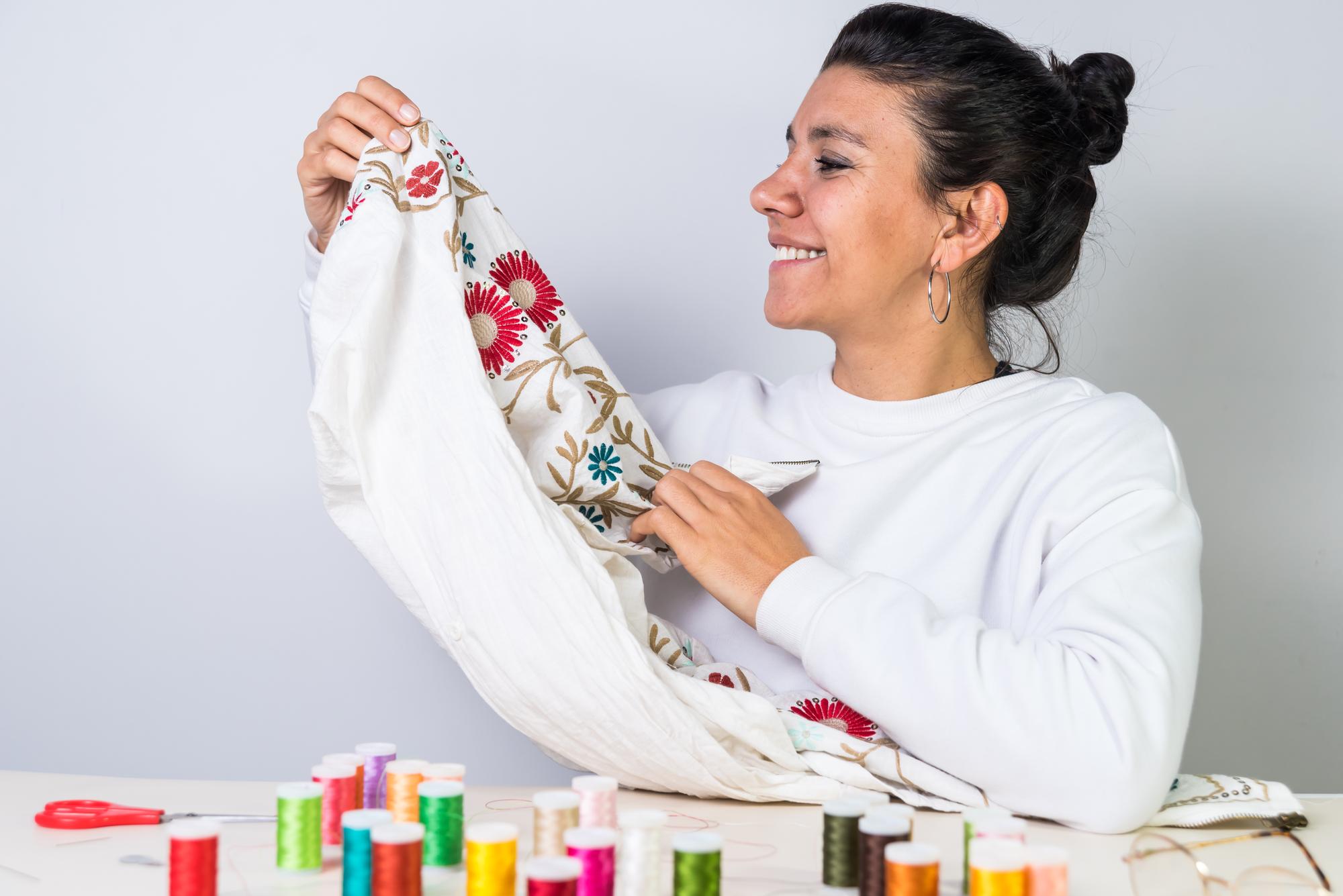 teacher demonstrating embroidery stitches to student